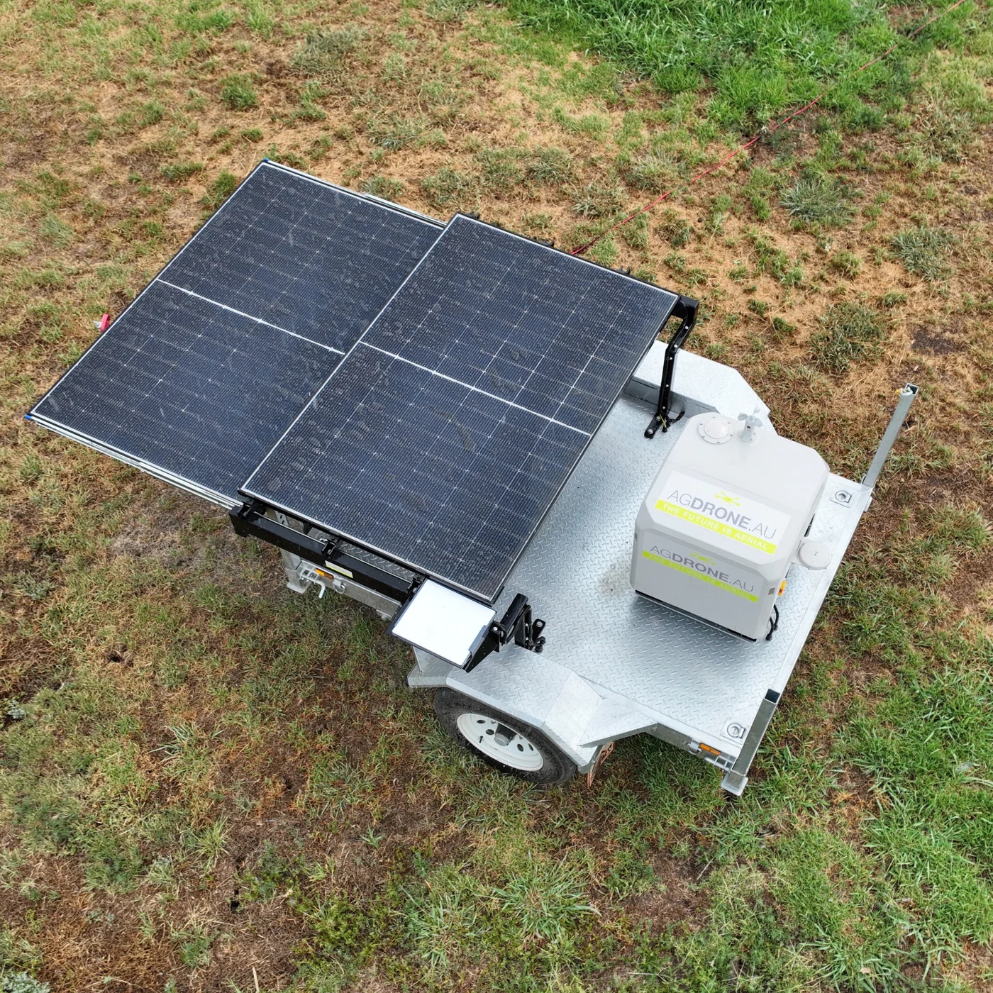 AgDrone AgDock trailer system with solar panels and DJI Dock deployed in a field